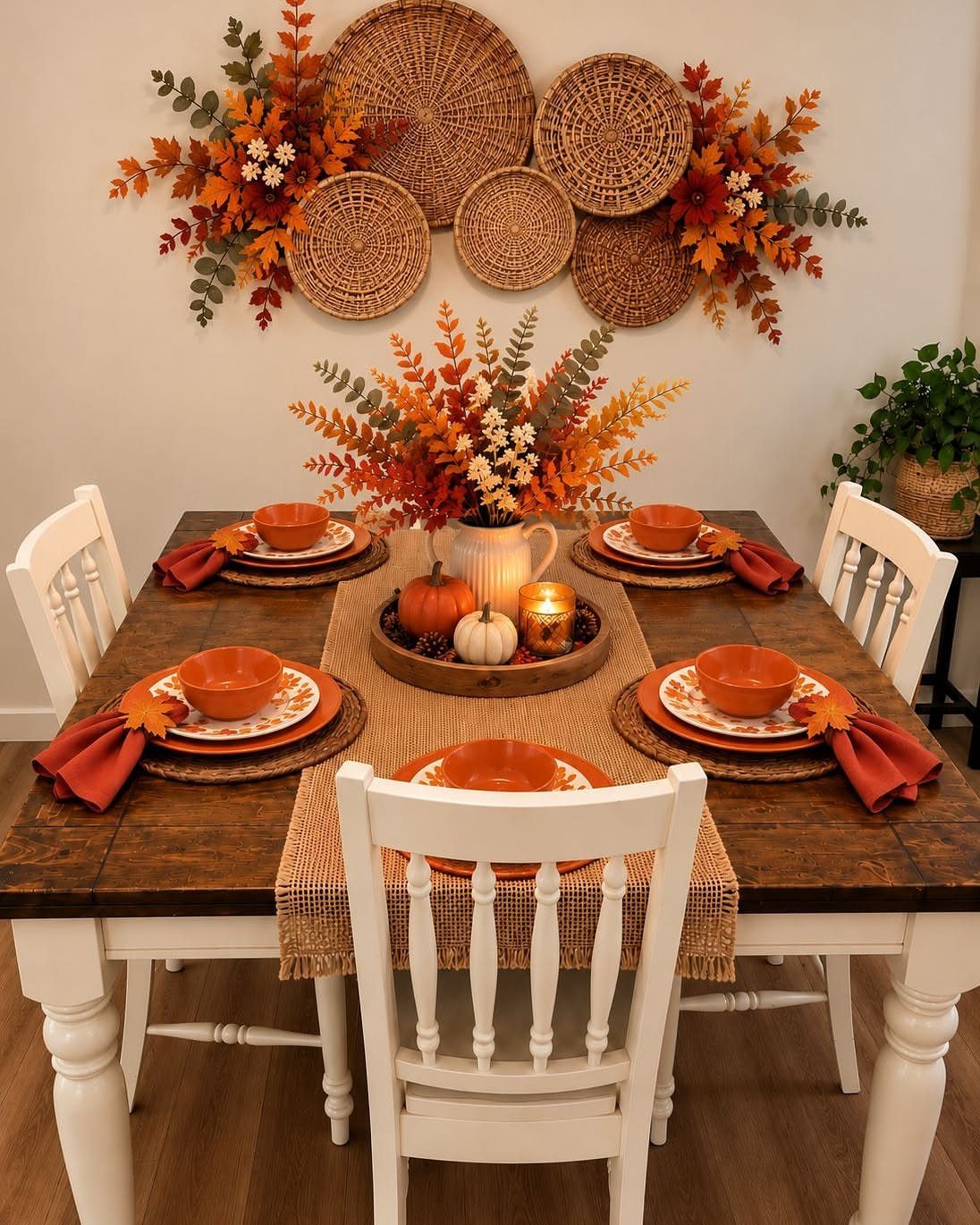 18 Autumn Dining Room Decor Ideas for a Warm and Inviting Space 17 Autumn dining table setting with orange tableware, burlap runner, and wall-mounted woven baskets.
