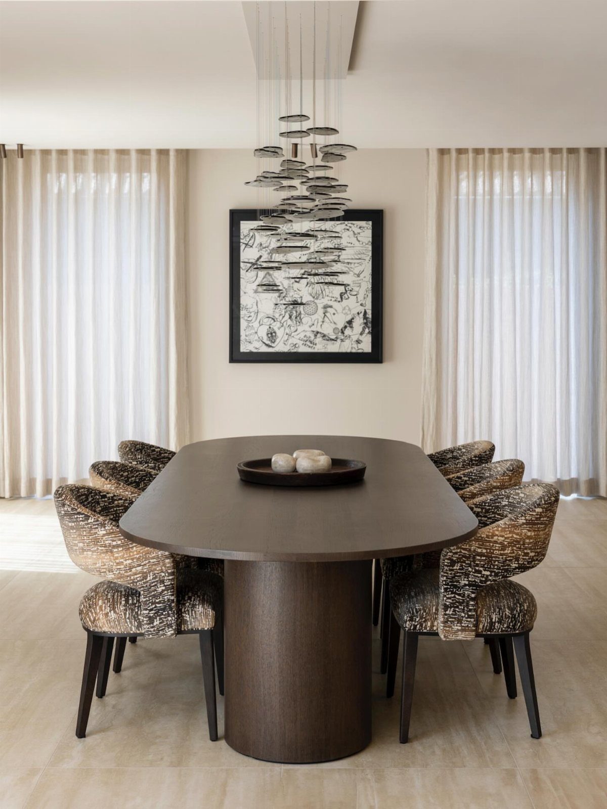 18 Autumn Dining Room Decor Ideas for a Warm and Inviting Space 12 Textured brown and cream upholstered dining chairs around a dark oval wooden table.