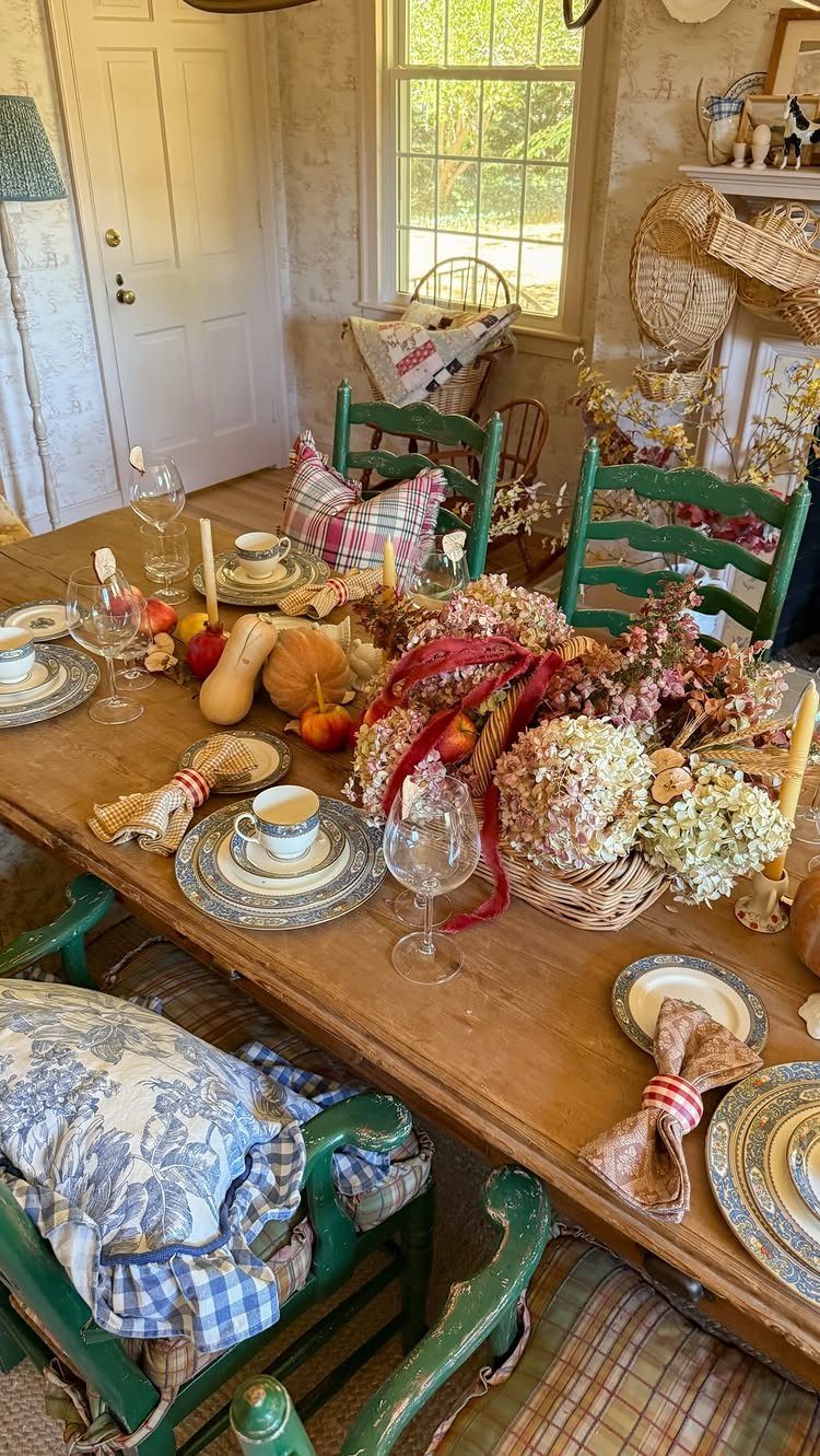 18 Autumn Dining Room Decor Ideas for a Warm and Inviting Space 8 Rustic wooden dining table with layered plates and a harvest-themed floral centerpiece.