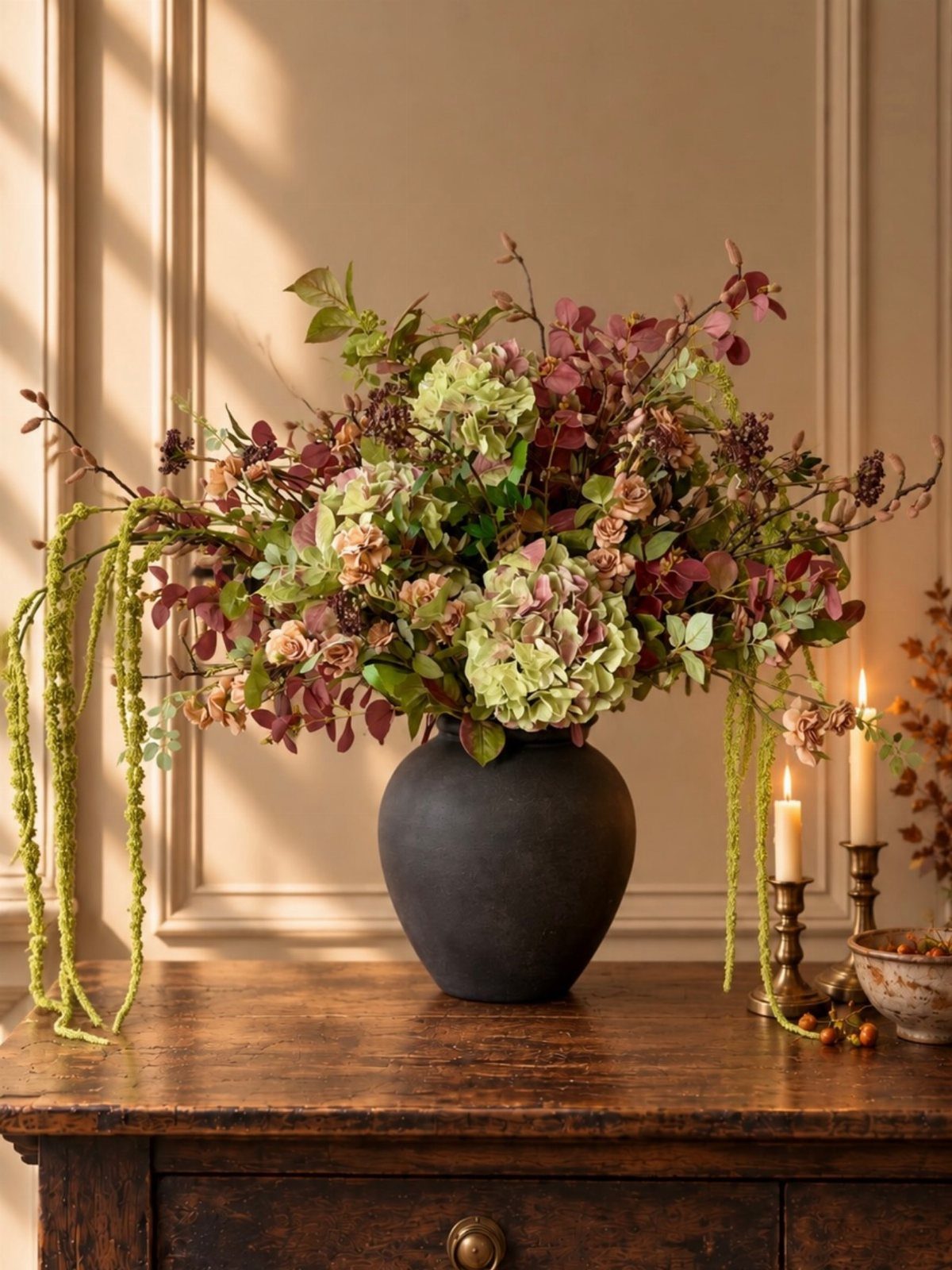 18 Autumn Dining Room Decor Ideas for a Warm and Inviting Space 15 Autumn floral arrangement with hydrangeas and burgundy leaves in a black vase on wood.