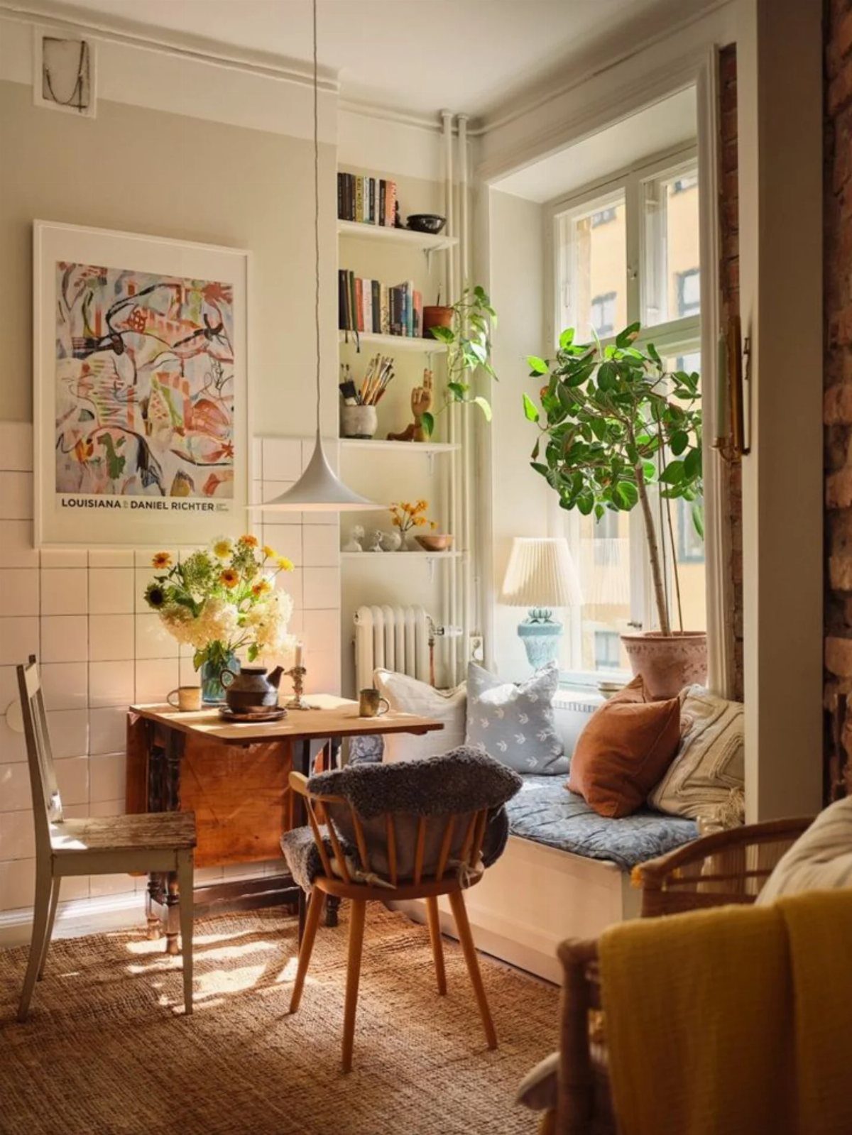 12 Bohemian Chic Dining Room Ideas for Effortless Style 2 Small wooden dining table with mismatched grey and mid-century modern chairs in bright room.