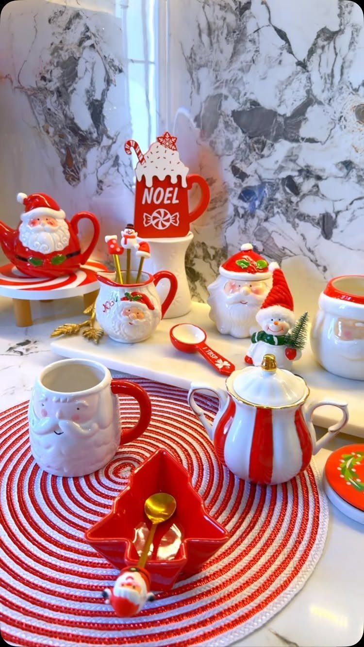 15 Christmas Coffee Table Decor Ideas for a Festive Home 2 Christmas-themed ceramic mugs and containers arranged on a red and white circular placemat.