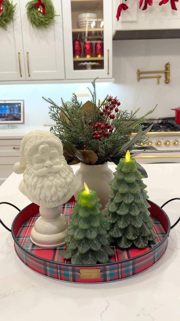 15 Christmas Coffee Table Decor Ideas for a Festive Home 4 Red plaid tray with Santa bust, tree candles, and evergreen berries on countertop