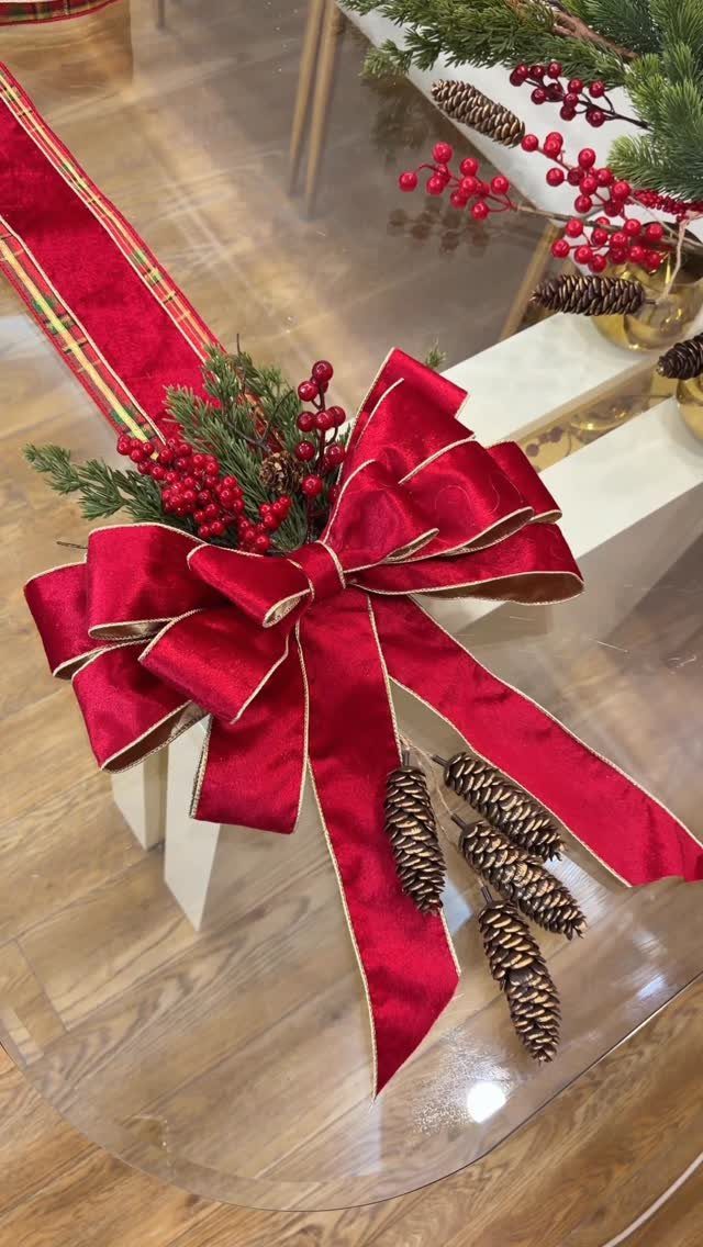 15 Christmas Coffee Table Decor Ideas for a Festive Home 14 Red ribbon bow with pinecones and berries on a glass coffee table