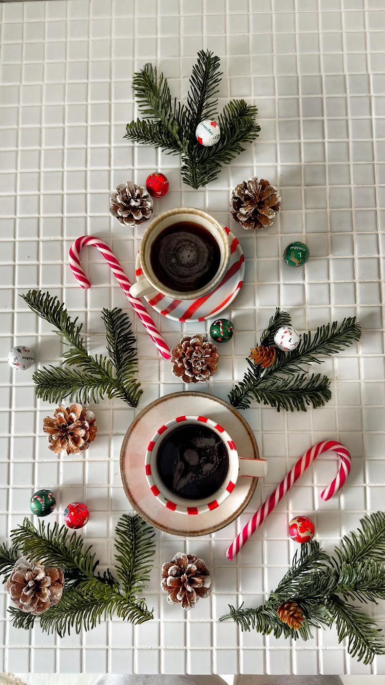 15 Christmas Coffee Table Decor Ideas for a Festive Home 13 Coffee cups and Christmas decorations arranged on a white grid coffee table.