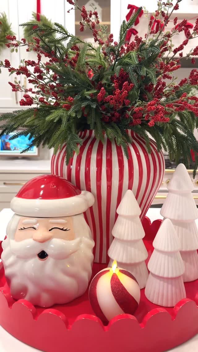 21 Christmas Decor Gift Ideas for the Holidays 9 Festive holiday display with Santa cookie jar, striped vase, and white ceramic trees.