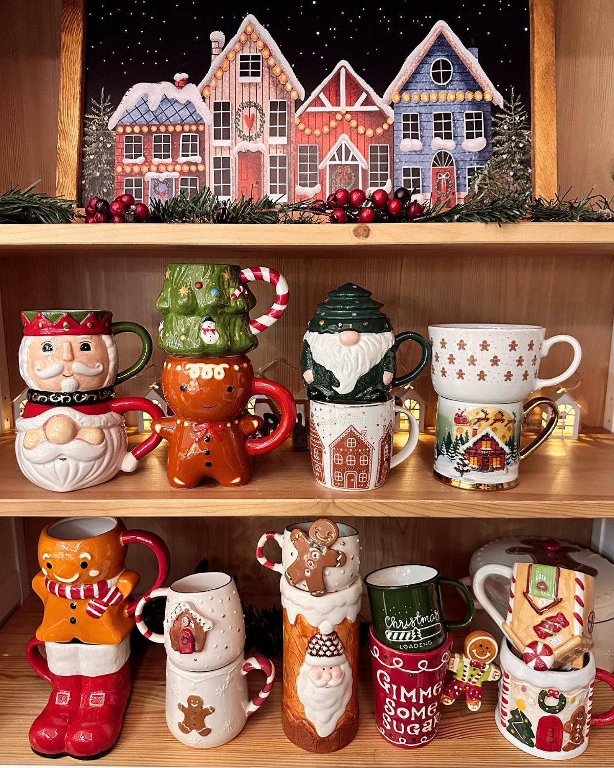 21 Christmas Decor Gift Ideas for the Holidays 10 Festive Christmas ceramic mugs with winter designs displayed on wooden shelves.