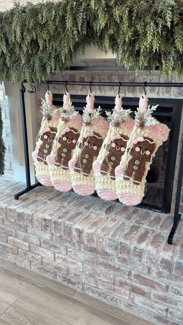21 Christmas Decor Gift Ideas for the Holidays 6 Crocheted gingerbread man Christmas stockings hanging from a rod by a brick fireplace.