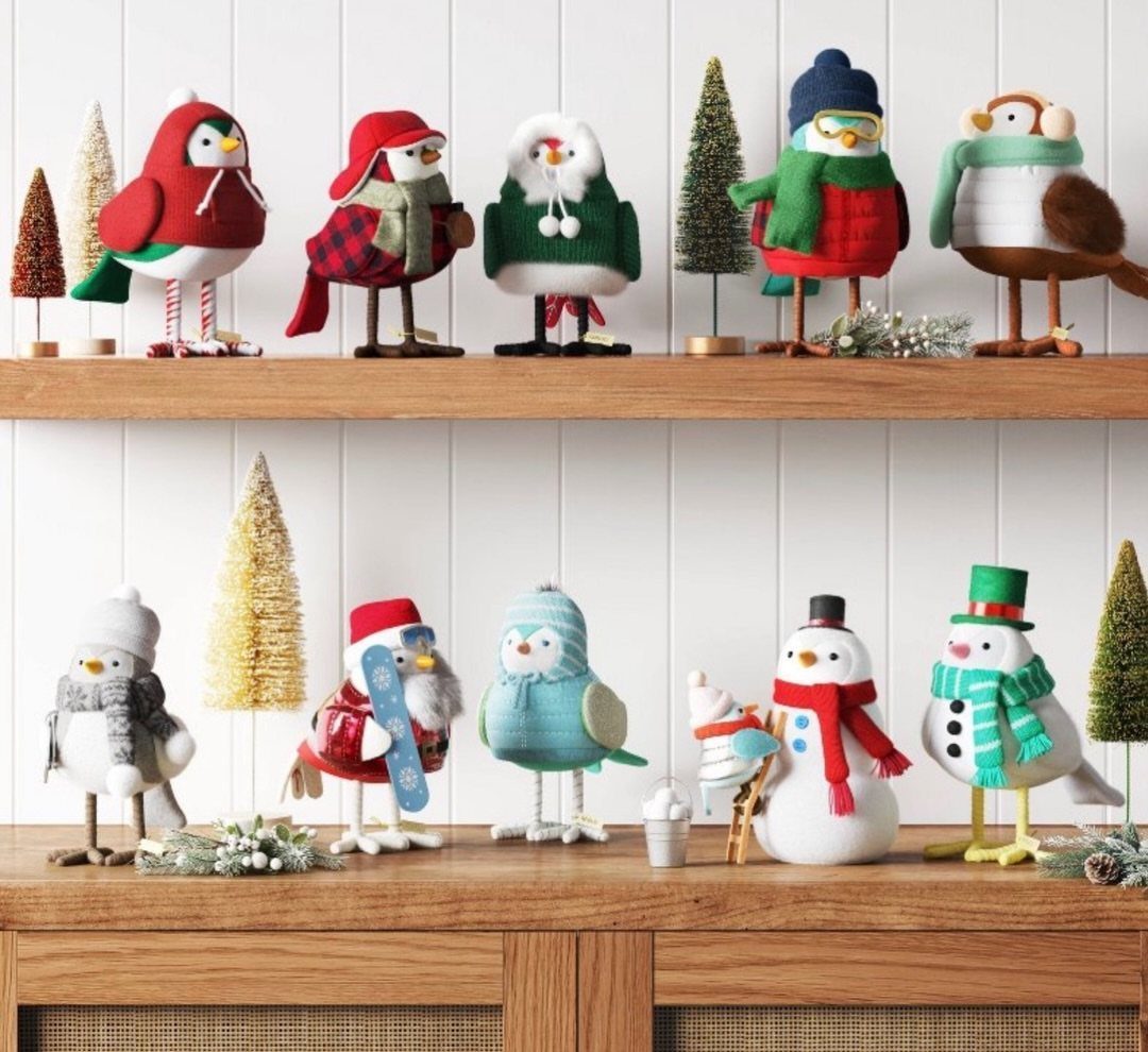 21 Christmas Decor Gift Ideas for the Holidays 13 Festive bird figurines in winter clothing arranged on wooden shelves with small trees.