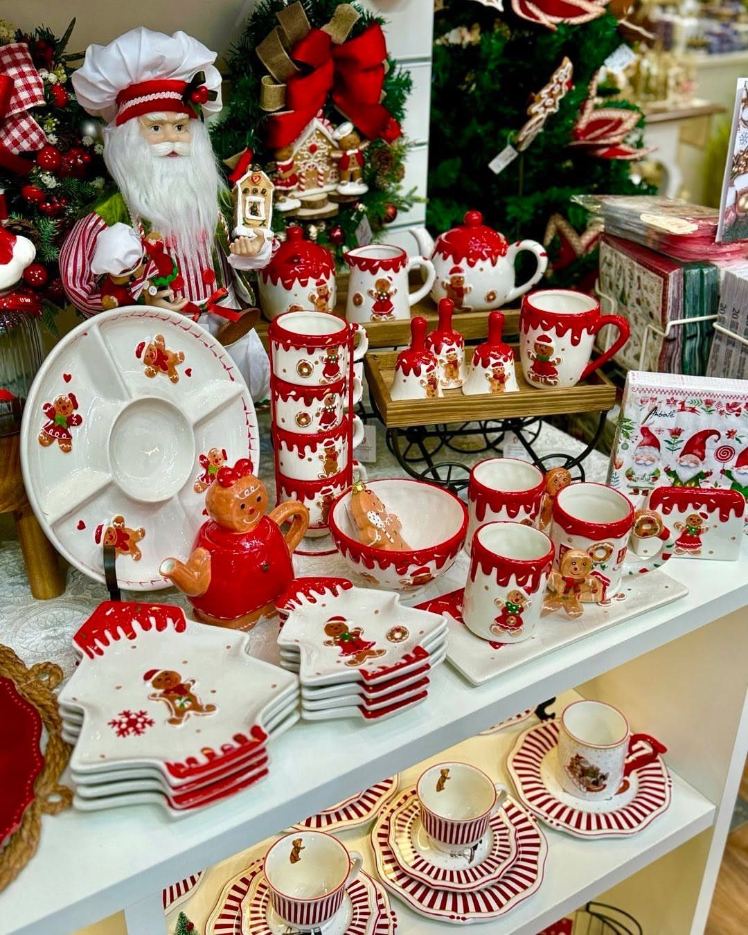 17 Christmas Decor Ideas with White for a Serene Home 14 White ceramic Christmas dinnerware with red accents and gingerbread designs on white shelves.