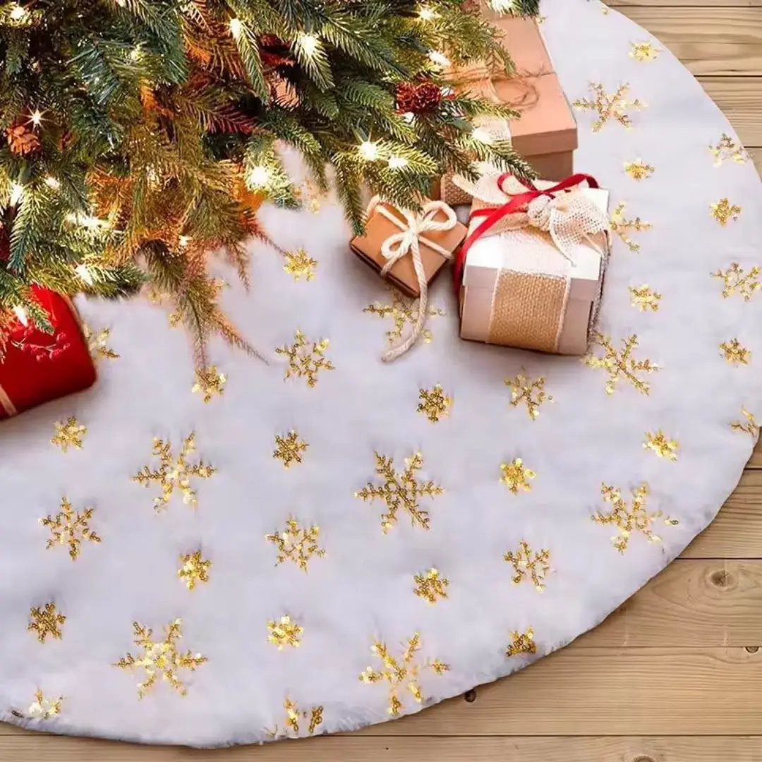 17 Christmas Decor Ideas with White for a Serene Home 13 White faux-fur tree skirt with gold snowflakes under a lit Christmas tree.
