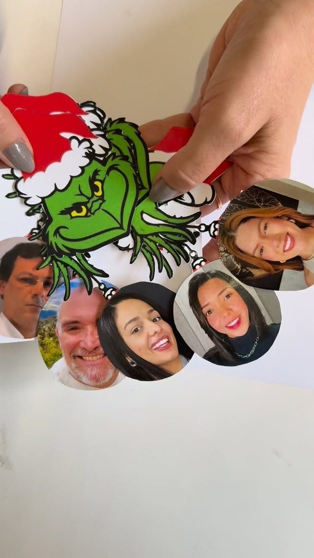 16 Christmas Decorations for Office Spaces That Shine 13 Grinch paper cutout with circular photos of coworkers attached to the bottom.