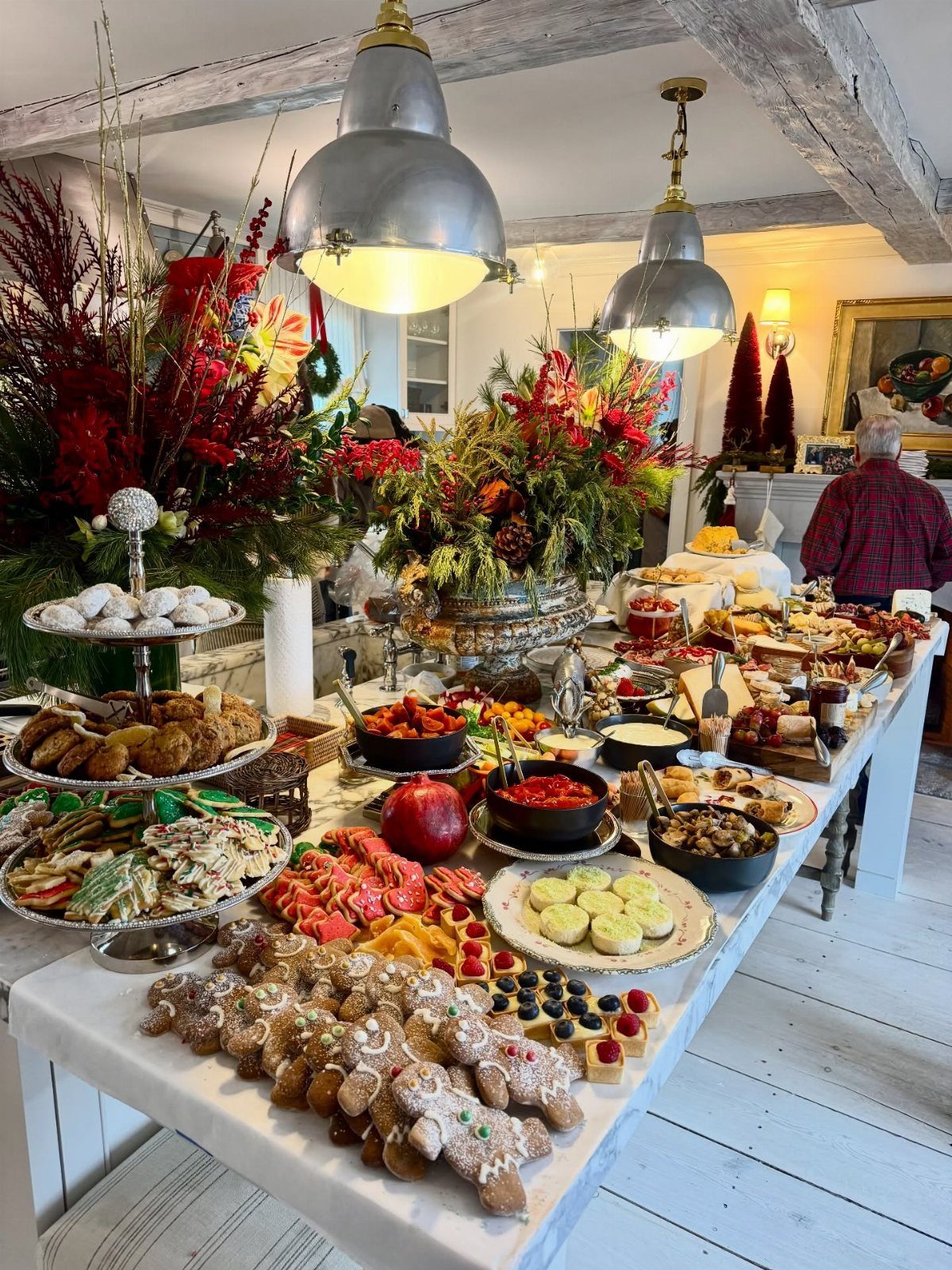 15 Christmas Dinner Party Ideas for a Festive Celebration 6 Festive dessert and appetizer spread on a white table with holiday decorations.