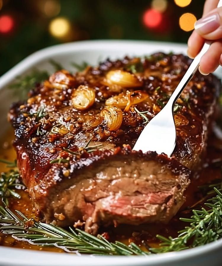15 Christmas Dinner Party Ideas for a Festive Celebration 13 Garlic and herb crusted rib roast with roasted garlic and rosemary in a dish.