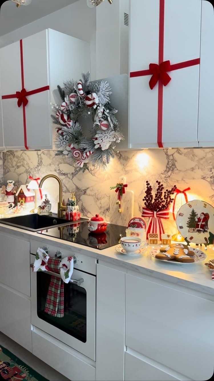 23 Christmas House Decorations Ideas for a Festive Home 21 White kitchen cabinets decorated with red ribbons and bows for Christmas holiday decor