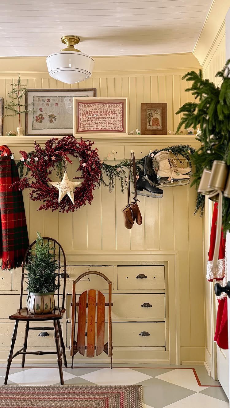 23 Christmas House Decorations Ideas for a Festive Home 7 Festive entryway with a red berry wreath, small pine tree, and vintage wooden sled.