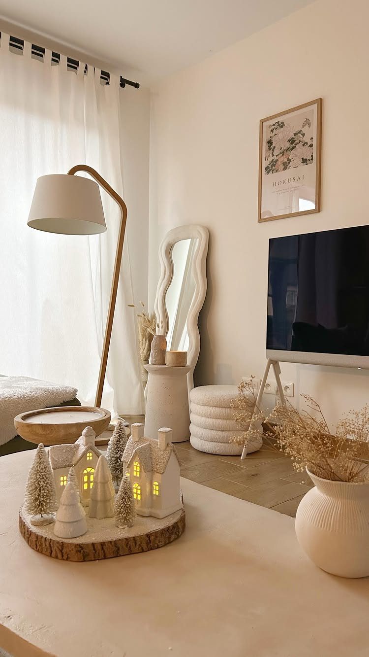 23 Christmas House Decorations Ideas for a Festive Home 20 Miniature white ceramic houses and frosted trees arranged on a wooden slice base.
