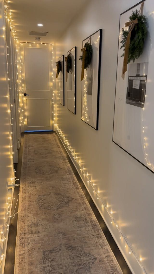 23 Christmas House Decorations Ideas for a Festive Home 19 Hallway decorated with warm fairy lights along the edges and framed wall art.