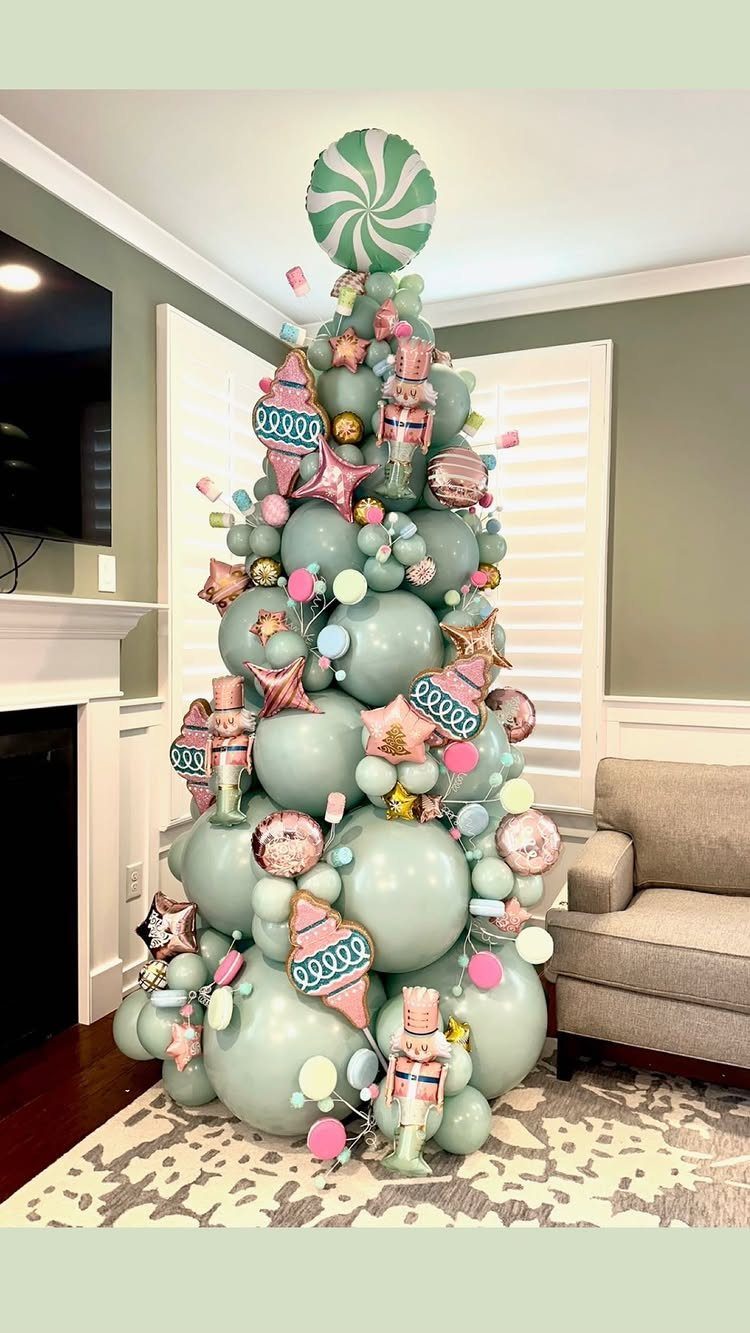 33 Christmas Party Decor Ideas to Bring the Holiday Magic 3 Balloon Christmas tree made of mint green balloons with nutcrackers and candy topper.