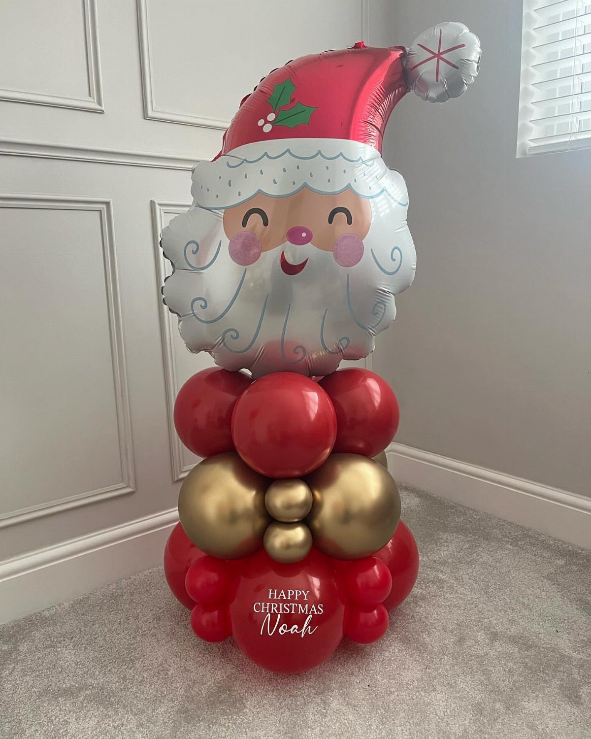 33 Christmas Party Decor Ideas to Bring the Holiday Magic 28 Santa Claus foil balloon on a base of red and gold balloons.