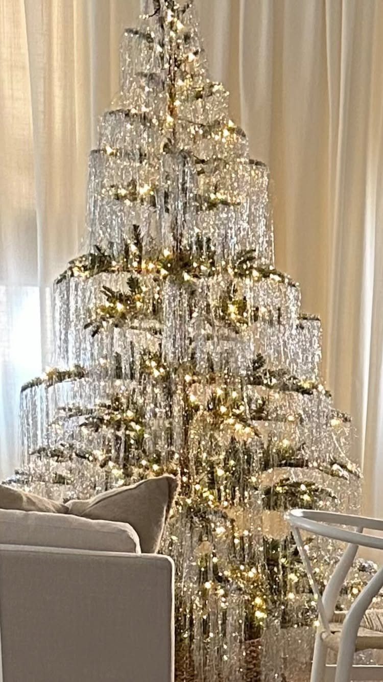 33 Christmas Party Decor Ideas to Bring the Holiday Magic 11 Christmas tree decorated with cascading clear crystals and warm white fairy lights.