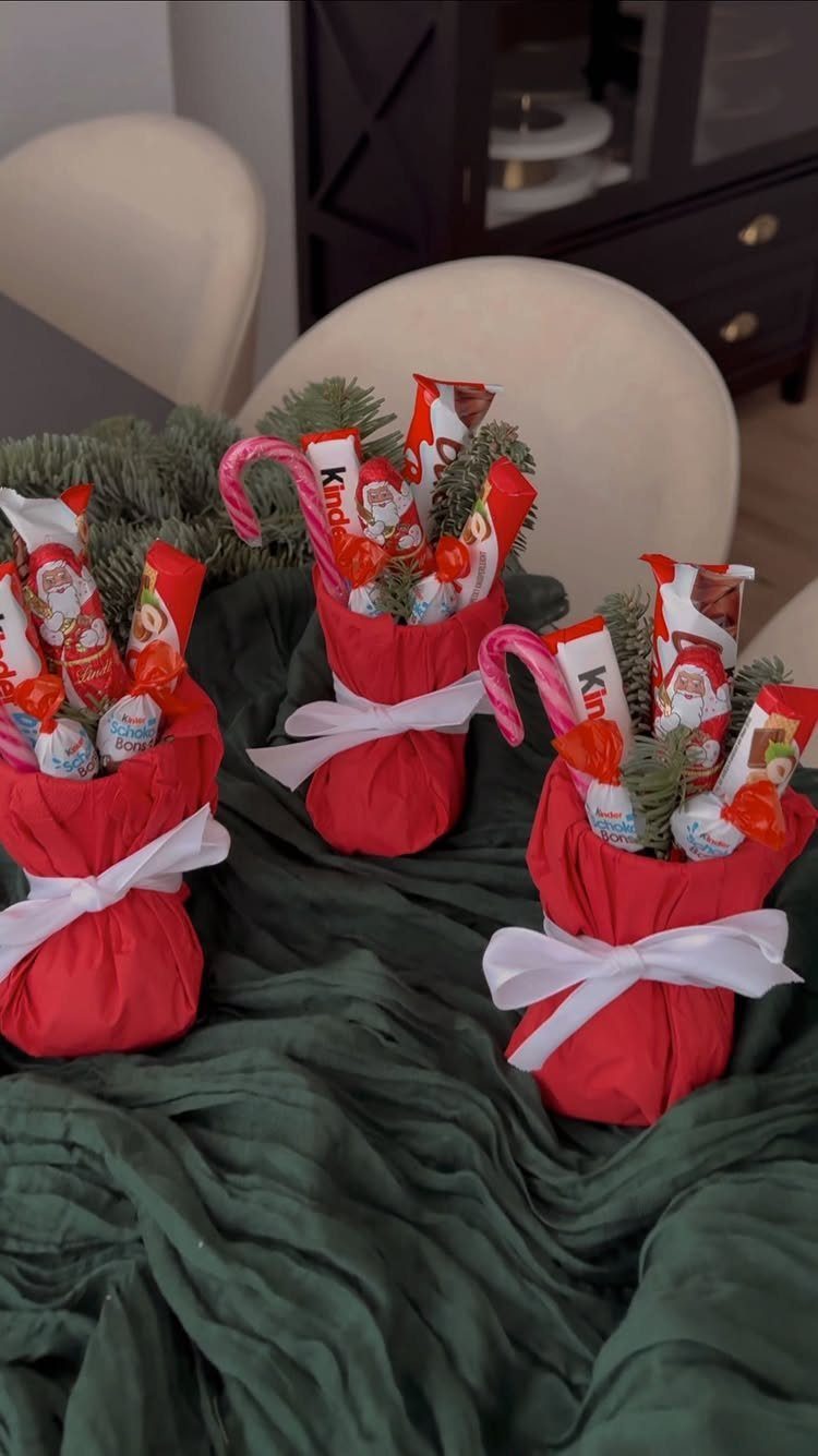 33 Christmas Party Decor Ideas to Bring the Holiday Magic 25 Red fabric pouches with white ribbons containing candy canes and evergreen sprigs.