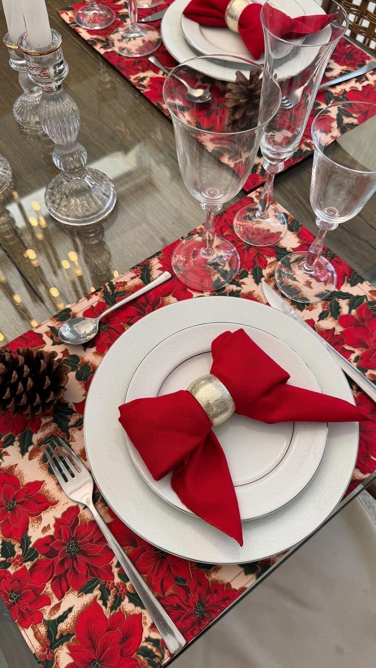 33 Christmas Party Decor Ideas to Bring the Holiday Magic 26 Festive table setting with red napkins in gold rings on floral placemats.