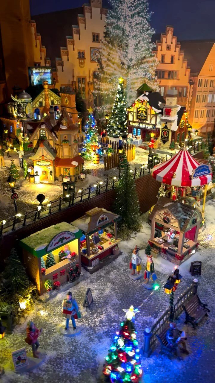 33 Christmas Party Decor Ideas to Bring the Holiday Magic 17 Miniature Christmas village with glowing houses, small trees, and tiny figures in snow.