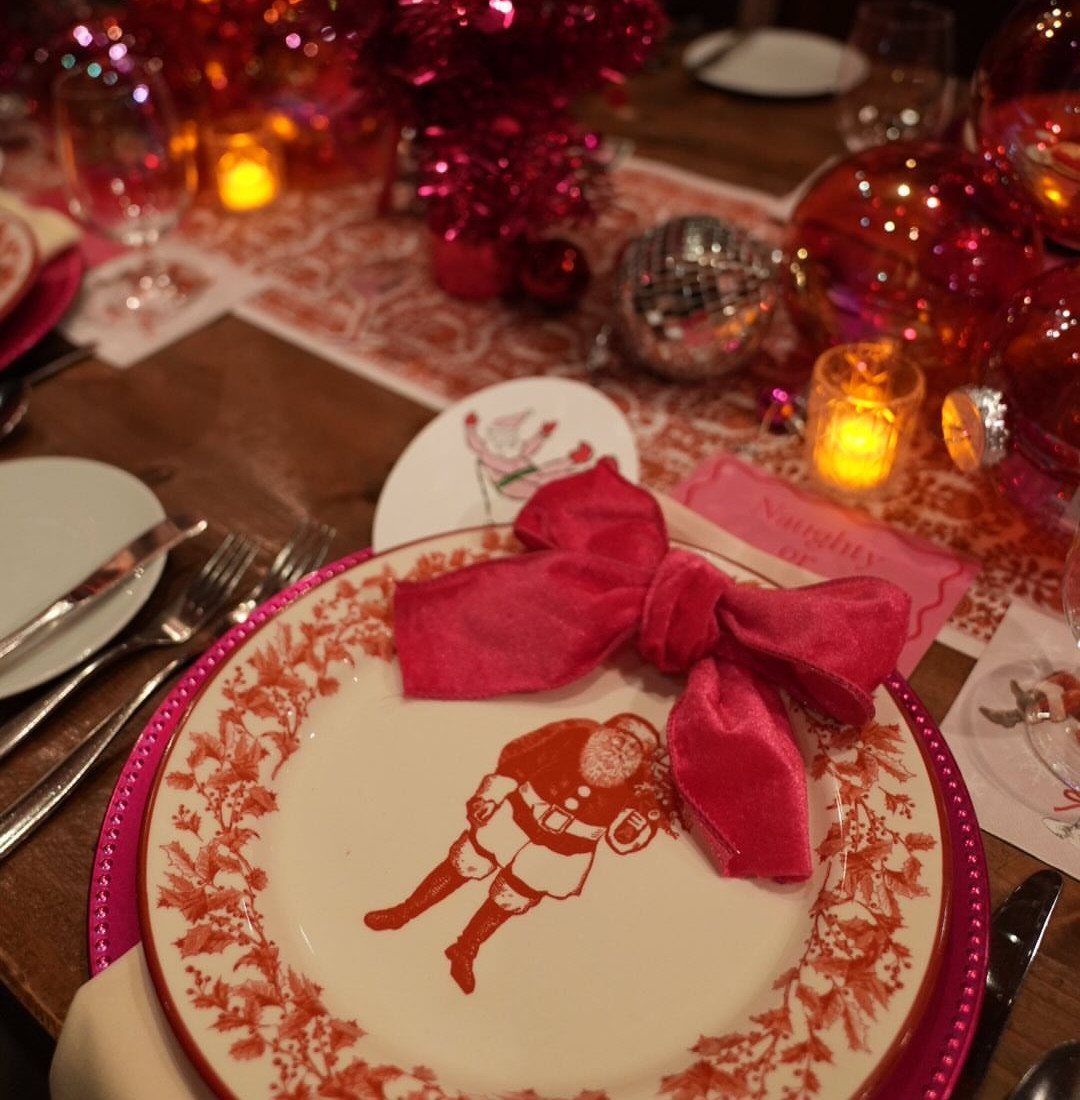 33 Christmas Party Decor Ideas to Bring the Holiday Magic 33 Festive table setting with Santa plate, red velvet bow, and pink place card.