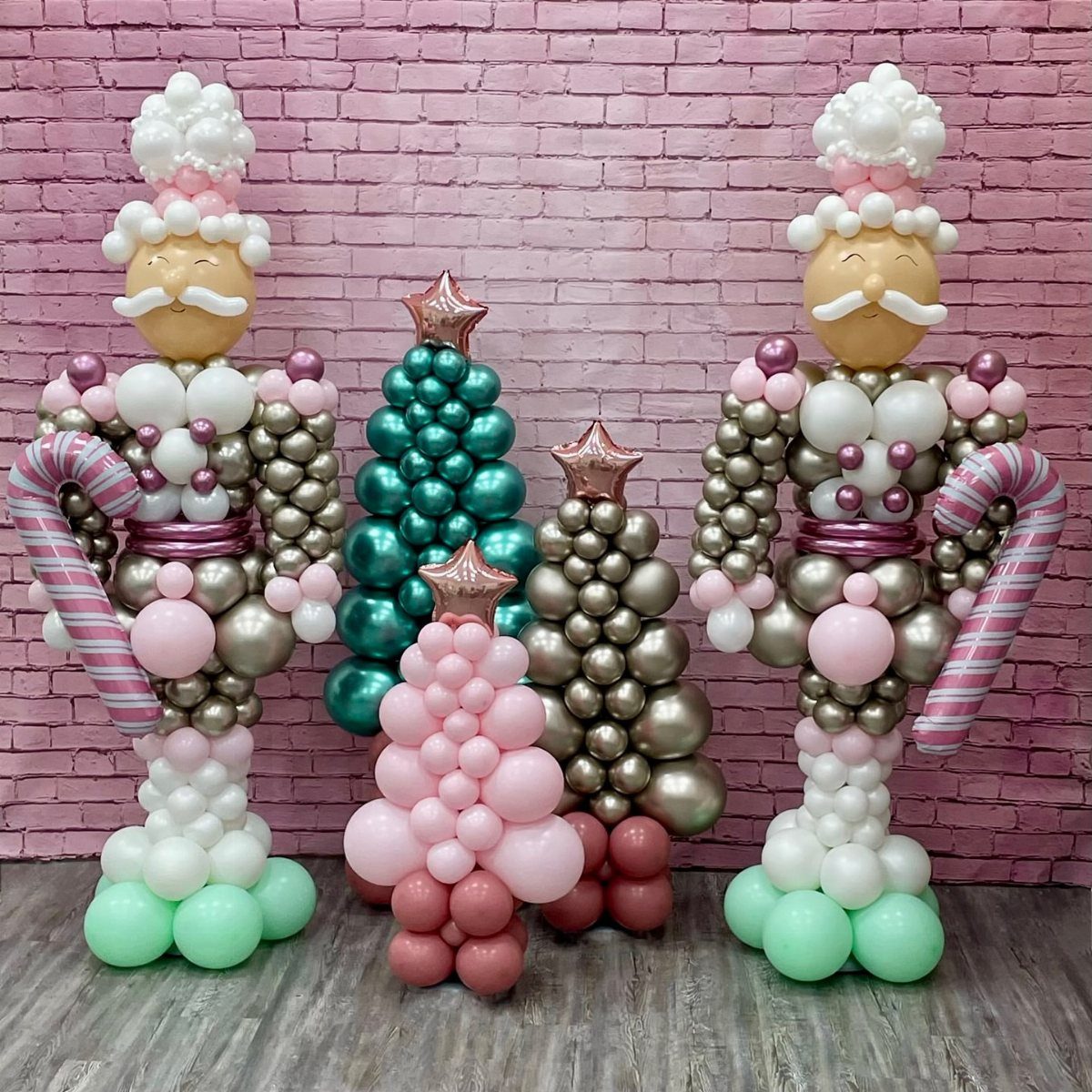 33 Christmas Party Decor Ideas to Bring the Holiday Magic 15 Life-size balloon nutcrackers and Christmas trees in pink, gold, and green colors.