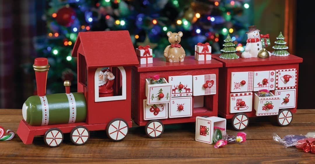 33 Christmas Party Decor Ideas to Bring the Holiday Magic 30 Red toy train Advent calendar with numbered drawers and festive miniature decorations.