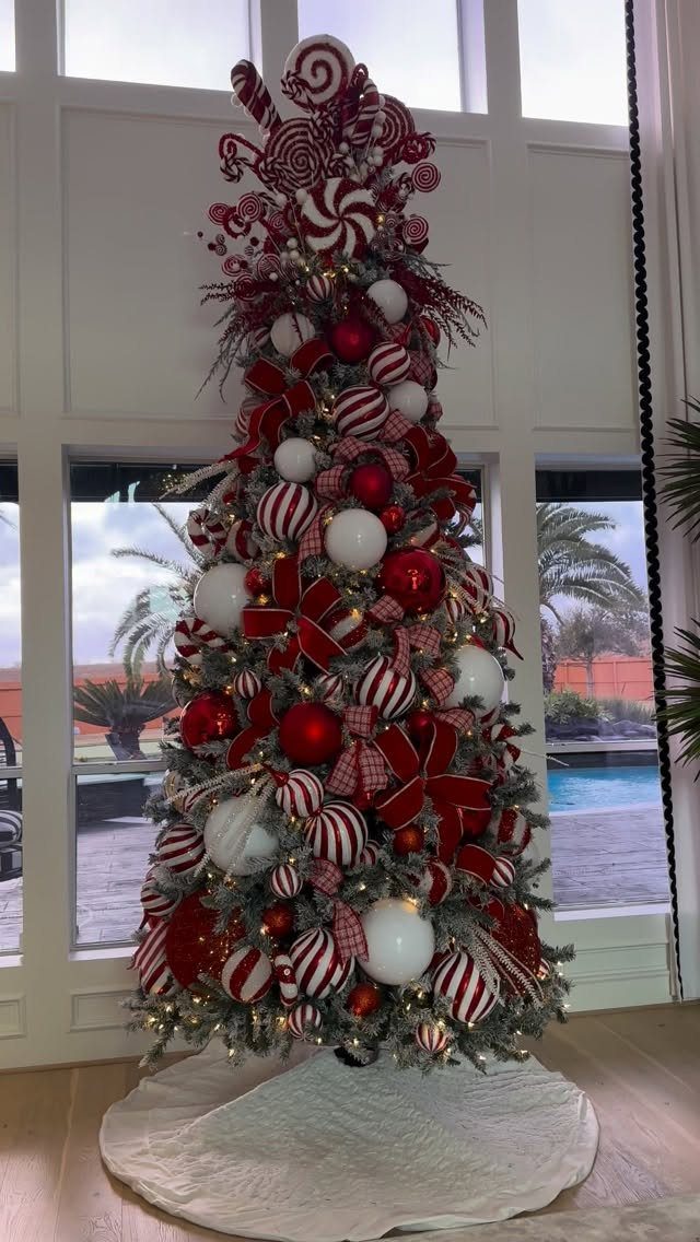Christmas tree decorated with red and white candy cane ornaments and peppermint swirls.