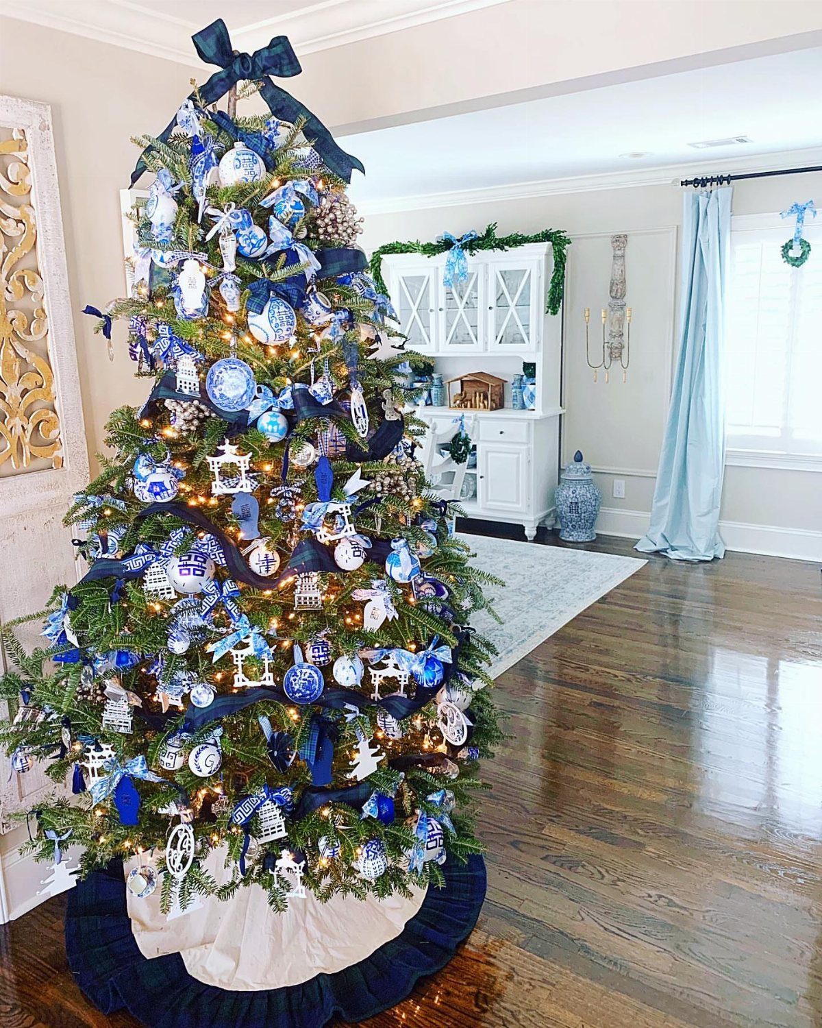 Christmas tree decorated with blue and white chinoiserie ornaments and navy blue ribbons.