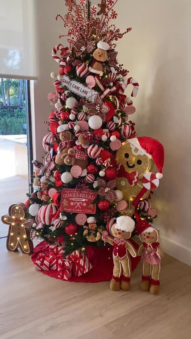 Christmas tree decorated with red and white ornaments and gingerbread man figures