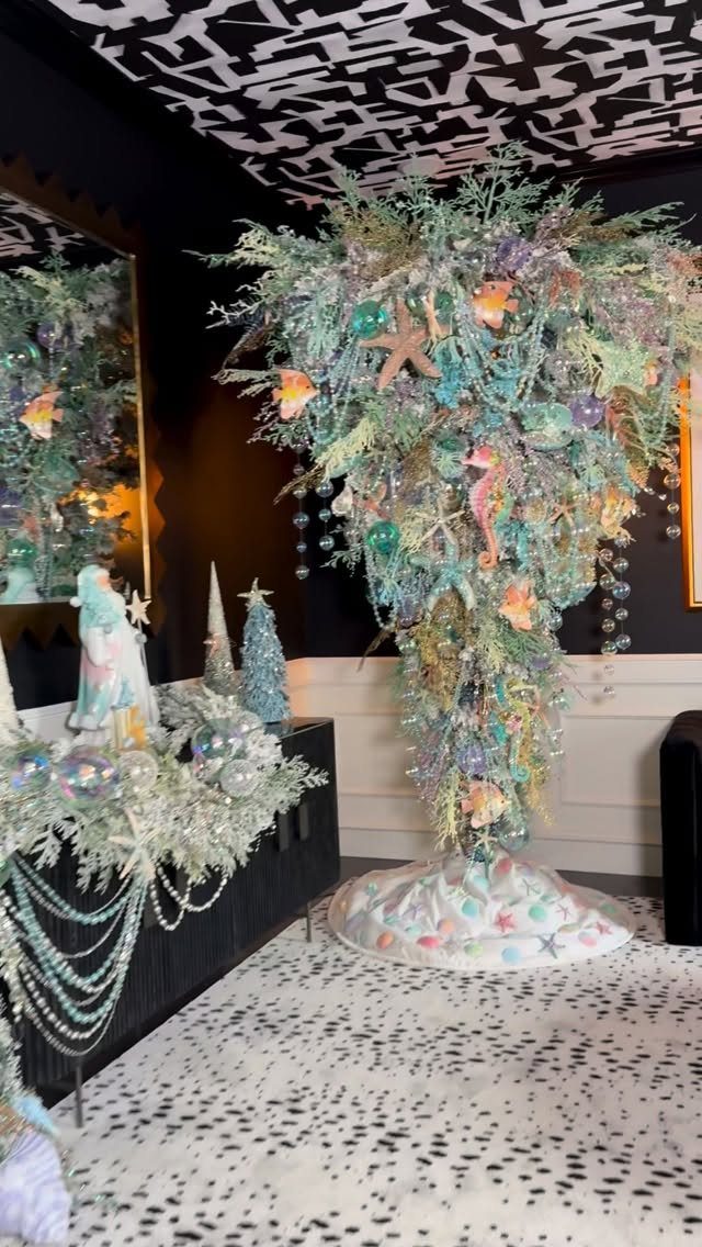 Under the sea themed Christmas tree with starfish, shells, and iridescent blue ornaments.