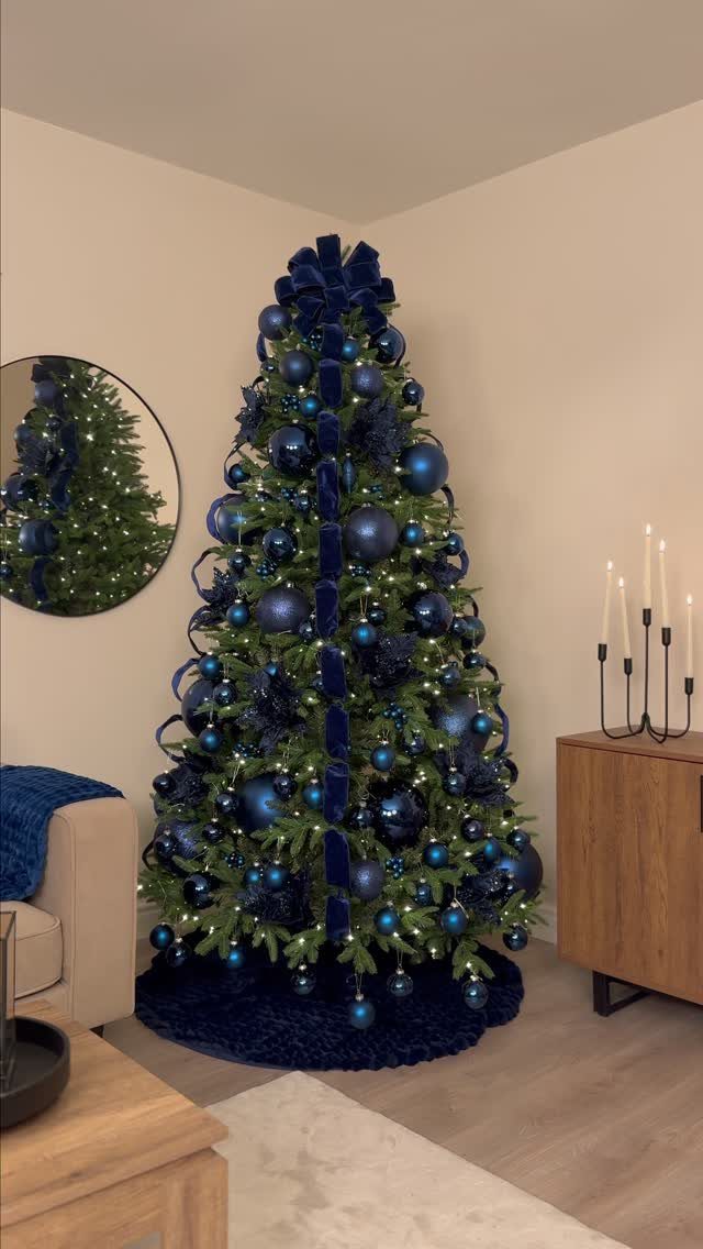 11 Christmas Tree Decorations with Ribbon Ideas 9 Christmas tree decorated with navy blue velvet ribbons and matching blue ornaments.