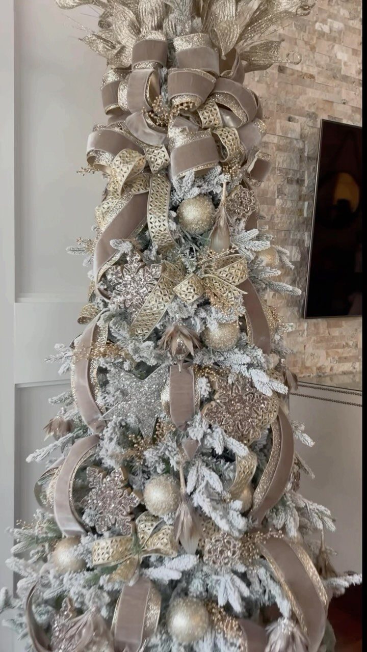 11 Christmas Tree Decorations with Ribbon Ideas 1 Flocked white Christmas tree adorned with layered gold velvet and glittery ribbons.