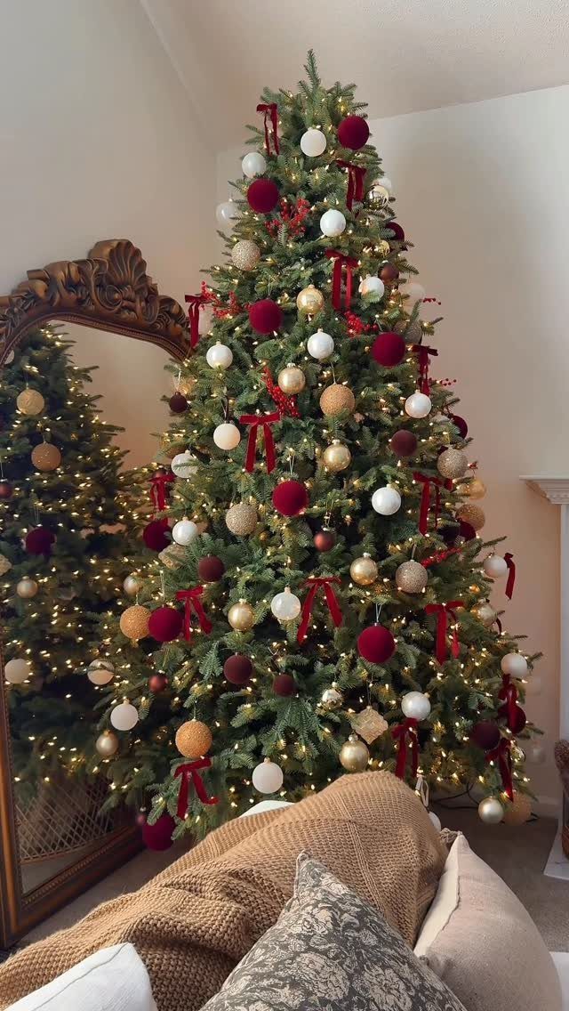 11 Christmas Tree Decorations with Ribbon Ideas 7 Decorated Christmas tree with red velvet ribbon bows and gold and white ornaments.