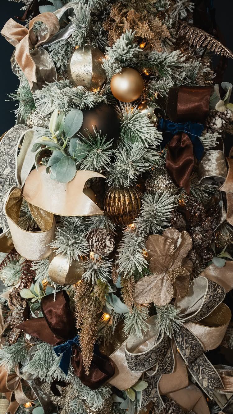 11 Christmas Tree Decorations with Ribbon Ideas 3 Decorated flocked Christmas tree featuring a mix of wide and narrow gold and brown ribbons.
