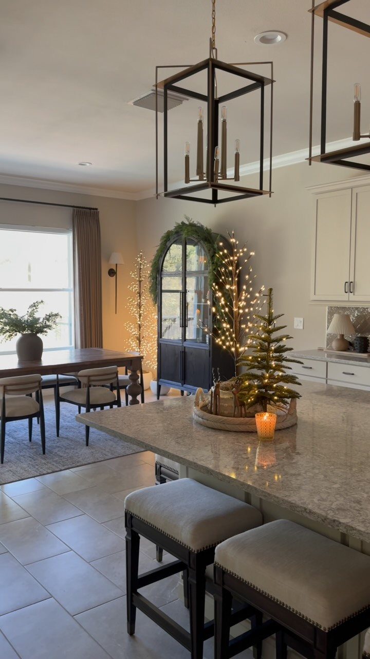5 Christmas Tree in Kitchen Ideas with Photos 5 Small lit Christmas tree on a marble kitchen island in a modern home.