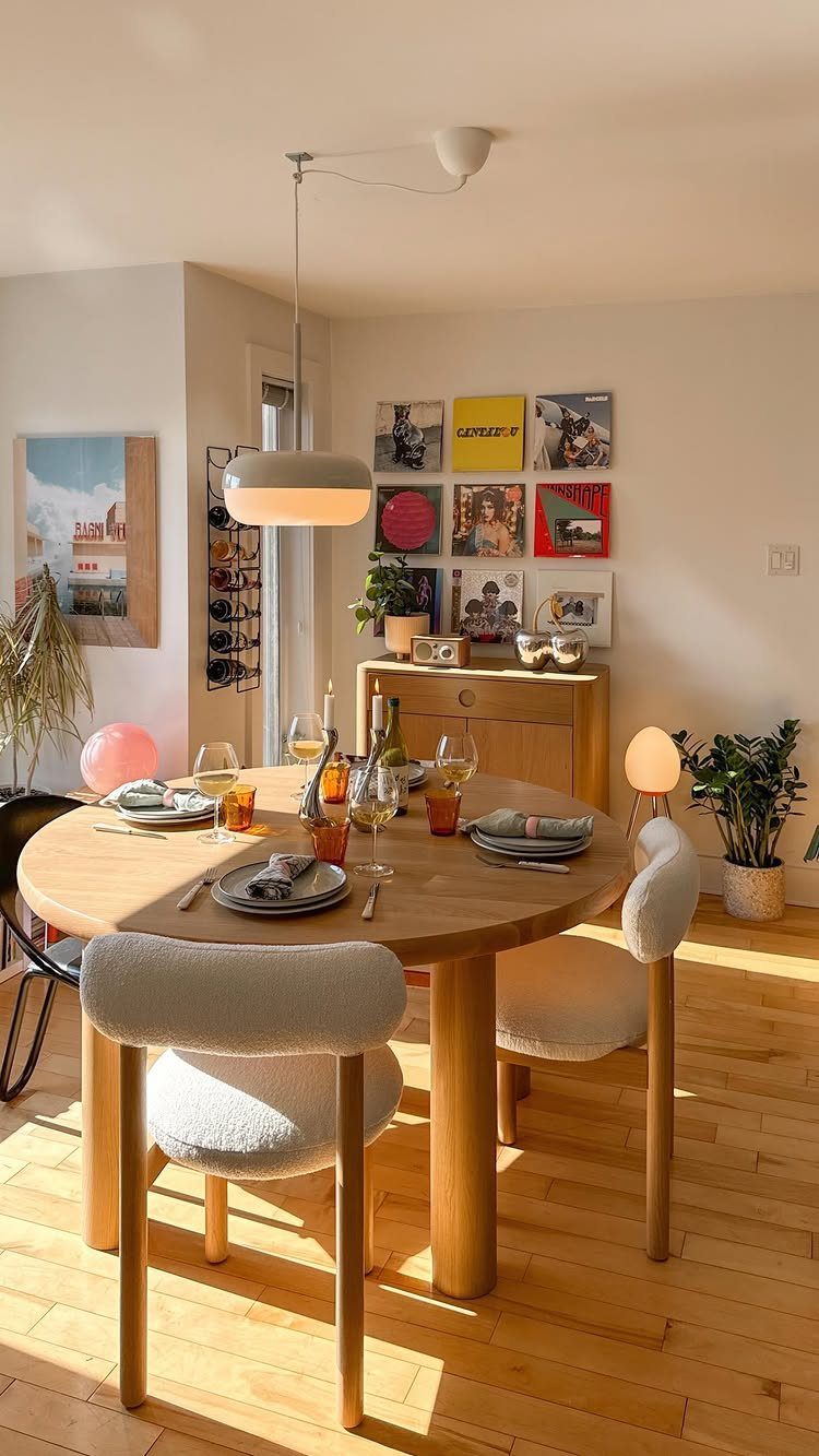 13 Contemporary Dining Room Decor Ideas for 2026 13 Round wooden dining table set with glassware and plates in a bright room.