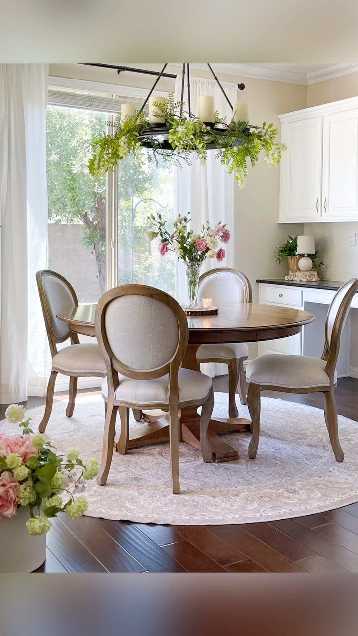 13 Contemporary Dining Room Decor Ideas for 2026 6 Round wooden dining table and chairs centered on a light circular area rug.