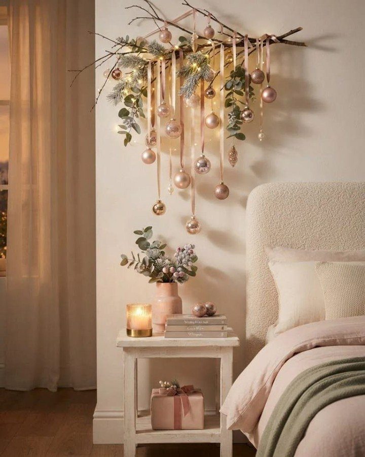 8 Cozy Christmas Bedroom Aesthetic Ideas to Try 6 Bedroom with rose gold Christmas branch decorations, fairy lights, and a cozy bed.