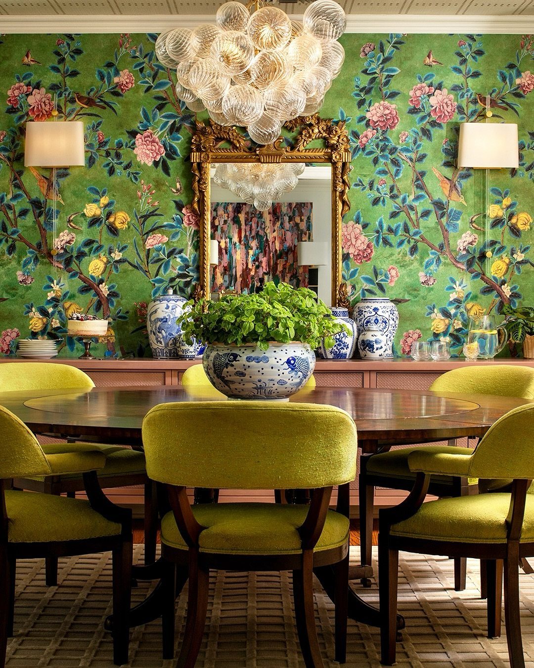 10 Ideas for Decorating a Dining Room Sideboard 4 Dining room with green chairs, wooden table, and blue porcelain vases on a sideboard.