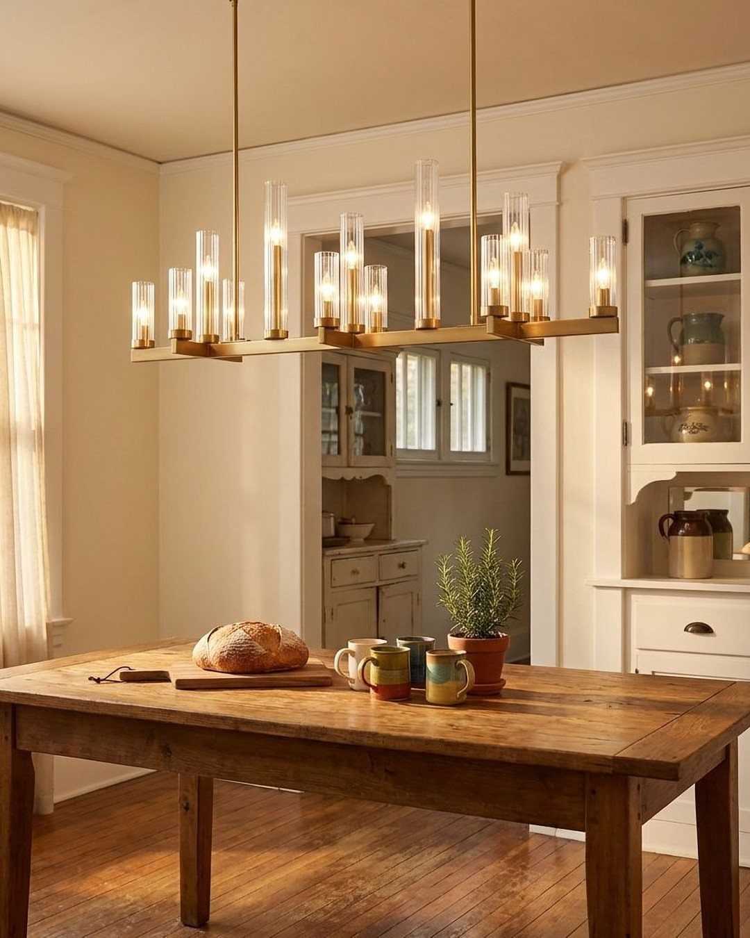 15 Dining Ideas for Small Spaces That Maximize Every Inch 14 Rustic wooden dining table with a modern gold cylindrical glass pendant light above.