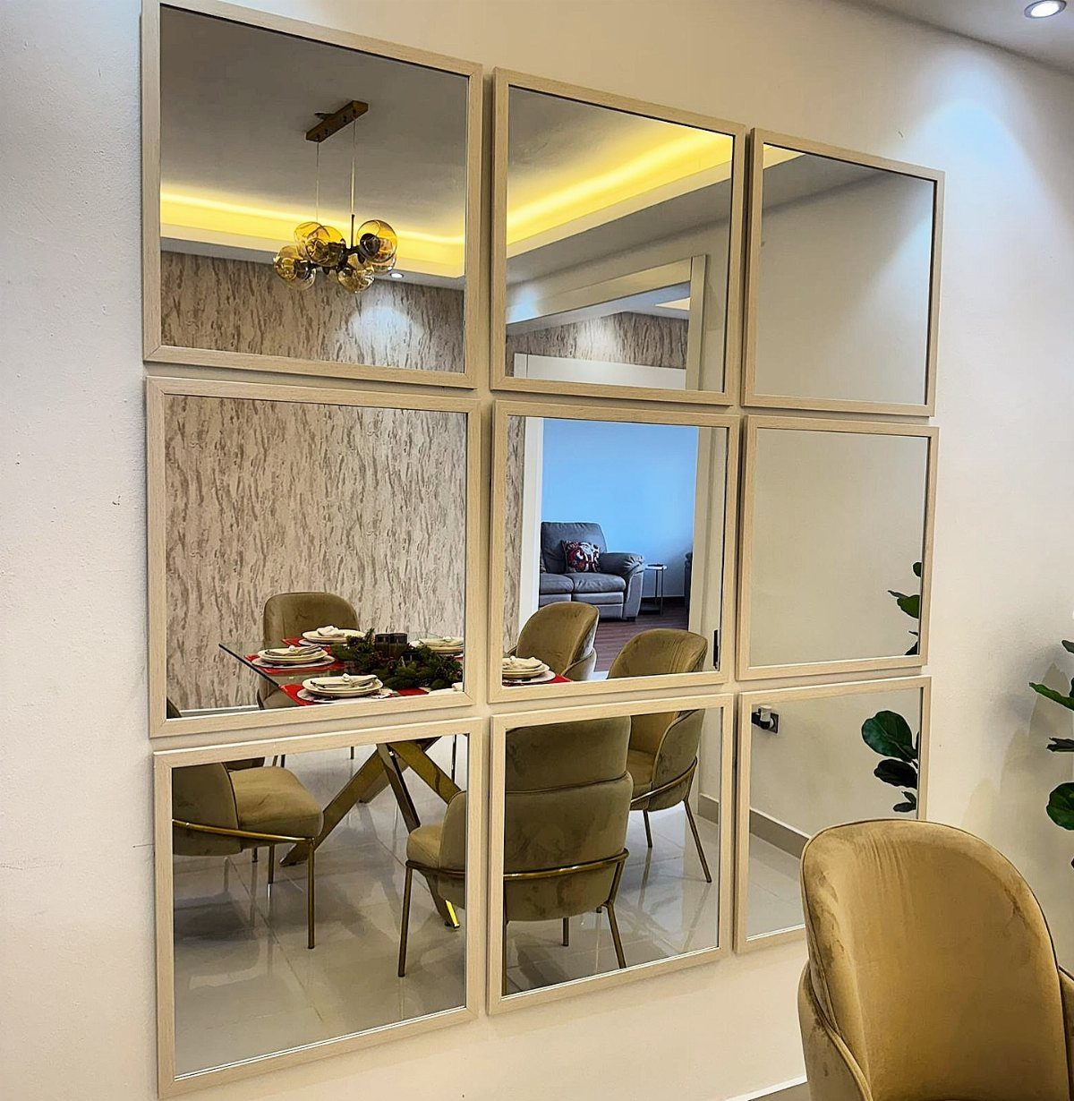 15 Dining Ideas for Small Spaces That Maximize Every Inch 4 Grid of gold-framed mirrors reflecting a modern dining room with gold chairs.