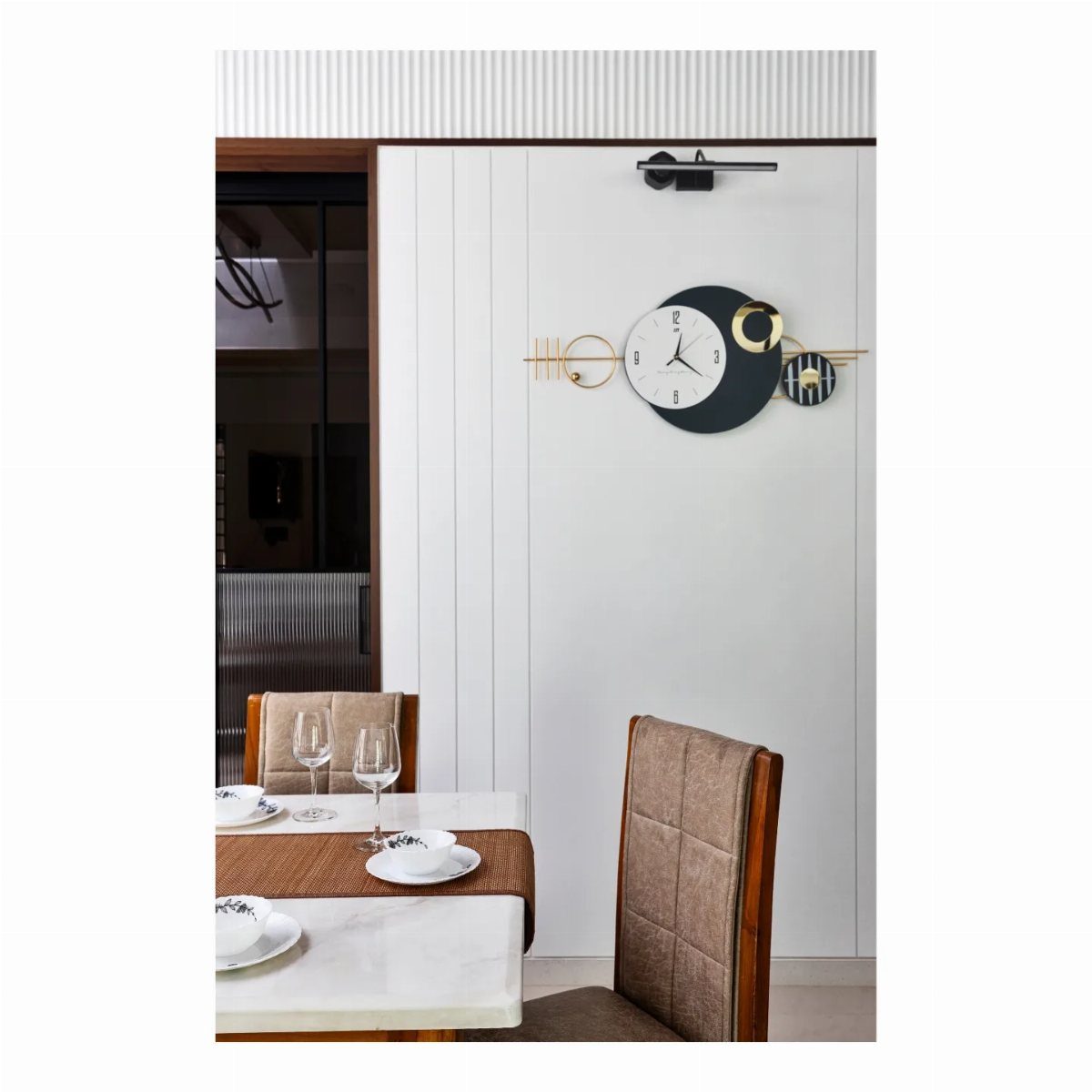 15 Dining Ideas for Small Spaces That Maximize Every Inch 8 White paneled wall with a modern clock above a set marble dining table.