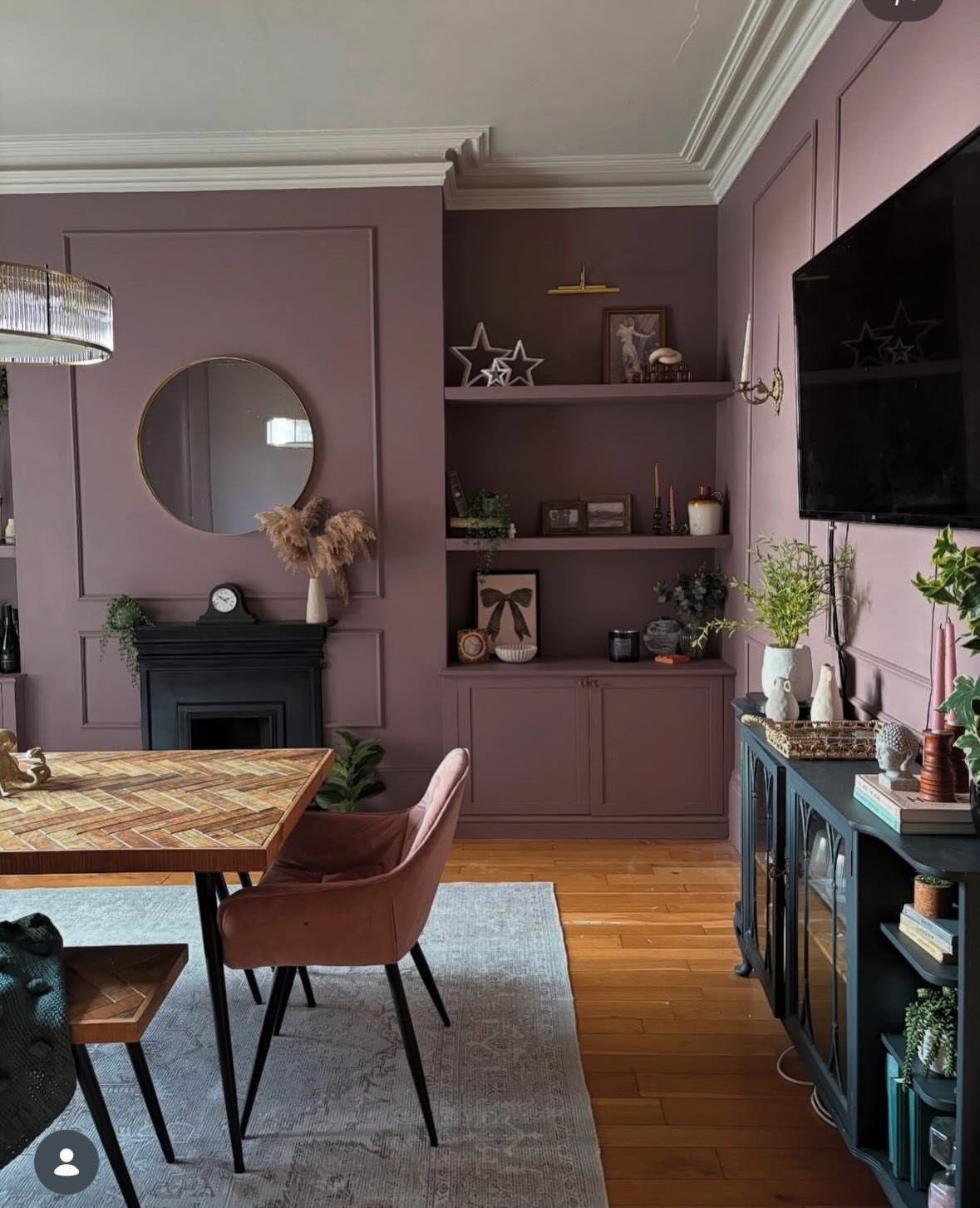 10 Dining Room Colors for 2027 That Feel Fresh and Grounded 8 Mauve dining room with built-in cabinetry, wooden table, and a velvet chair.