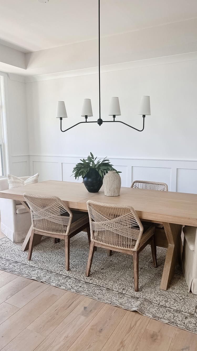 15 Dining Room Decor Modern Ideas with Style and Function 2 Light wood dining table and woven chairs set atop a neutral patterned rug.