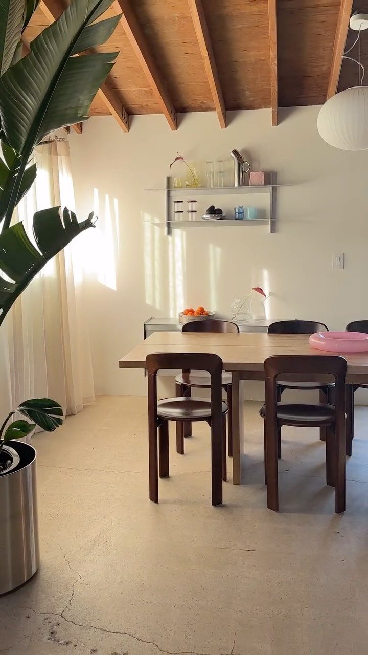15 Dining Room Decor Modern Ideas with Style and Function 7 Light wood dining table with dark brown chairs in a bright, modern room.